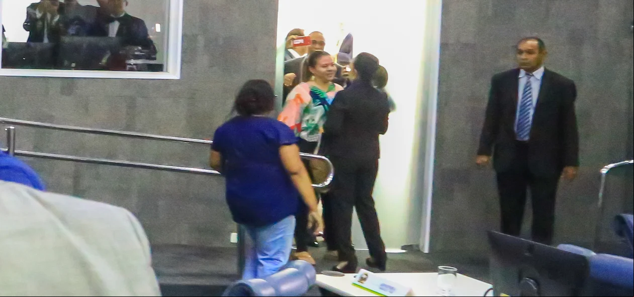 Momento em que Teresinha Medeiros é barrada por manifestante ao tentar sair do plenário 